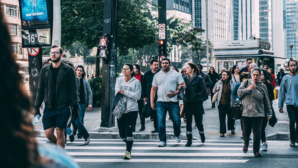 A crowd of people crossing the road